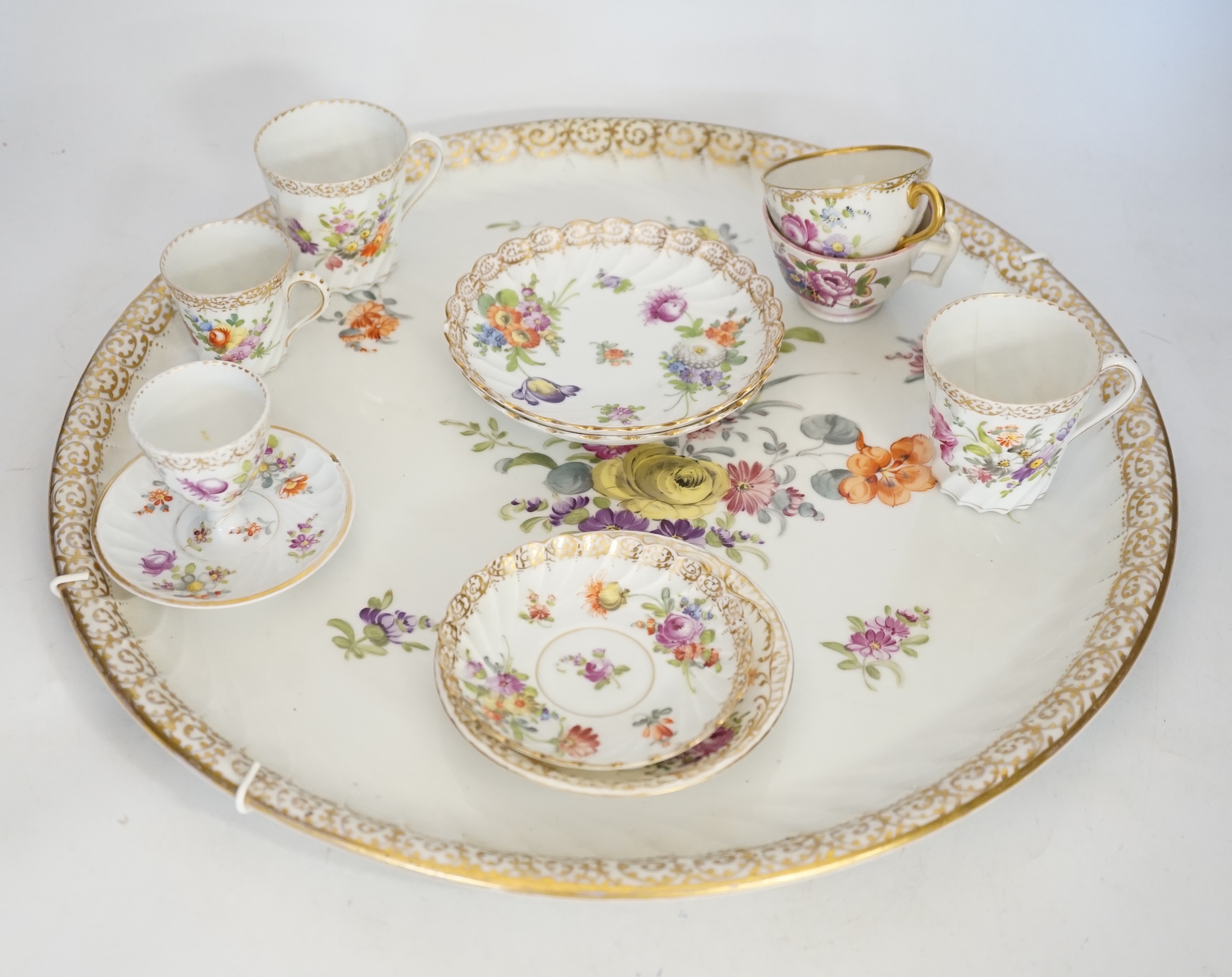 A Dresden floral painted tray and other coffee wares, 39cm diameter. Condition - poor to fair